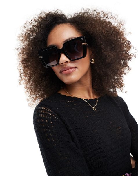 sunglasses boasts a cat-eye silhouette with glossy black accents
