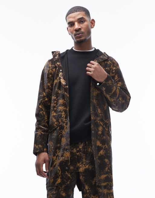 Rains – 12020 – Lange, wasserdichte Unisex-Kapuzenjacke in Braun mit Schlamm-Print