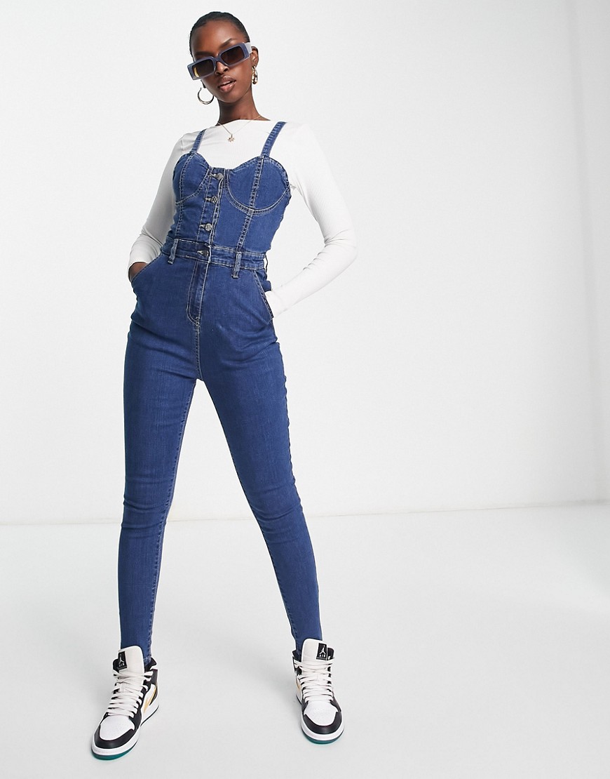 Rebellious Fashion strappy button front denim jumpsuit in mid blue