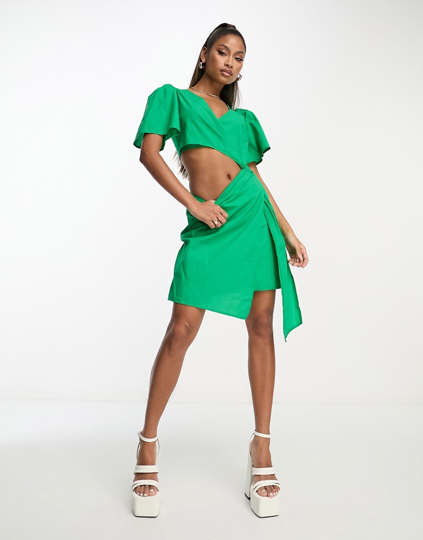 Rebellious Fashion wrap front linen look mini dress with assymmetric cut out in bright green