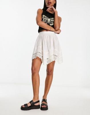 Reclaimed Vintage asymmetric hem mini skirt with lace trims in white