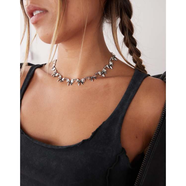 Reclaimed Vintage choker bow necklace in burnished silver | ASOS