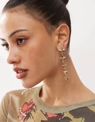 dangly star earrings in gold