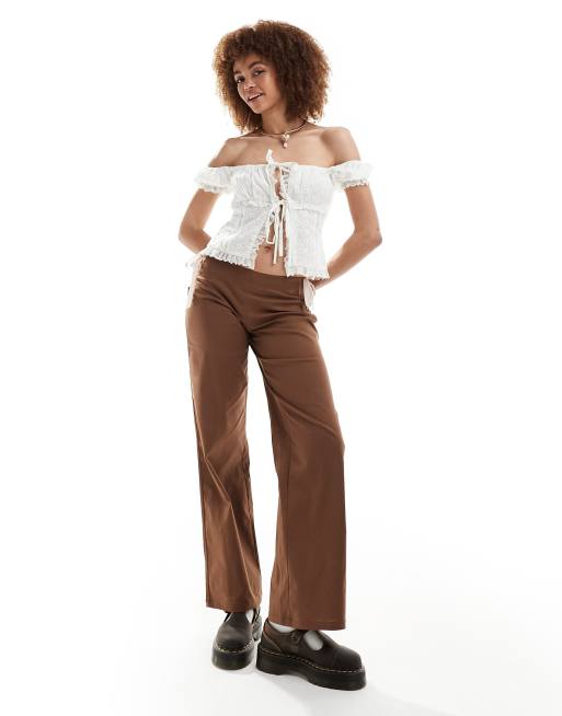 Reclaimed Vintage flare pants in brown with pink bows & ribbon