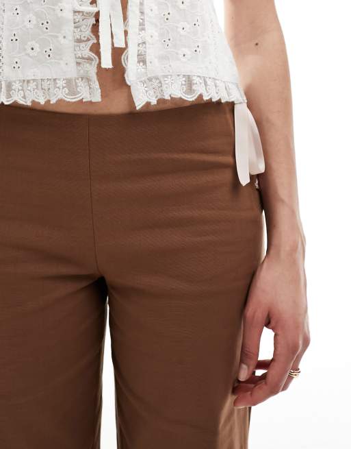 Reclaimed Vintage flare pants in brown with pink bows & ribbon