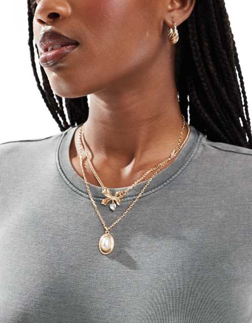 Reclaimed Vintage – Guldfärgat halsband med 2 rader, rosett och pärla