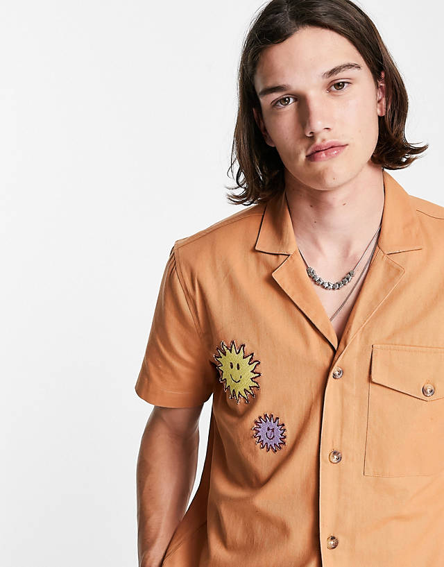 Reclaimed Vintage - inspired revere shirt with badges in tan co-ord
