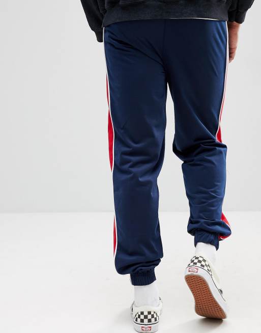 Reclaimed Vintage Inspired Track Trousers In Navy With Red Stripe