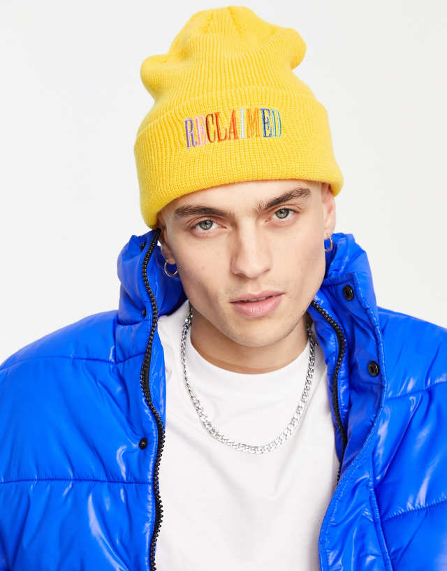 Reclaimed Vintage inspired unisex rainbow logo beanie in mustard 1