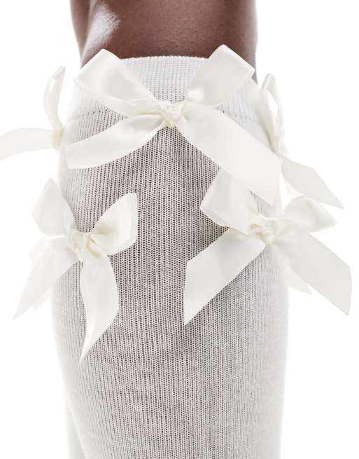 Reclaimed Vintage knee high socks with bows in white | ASOS