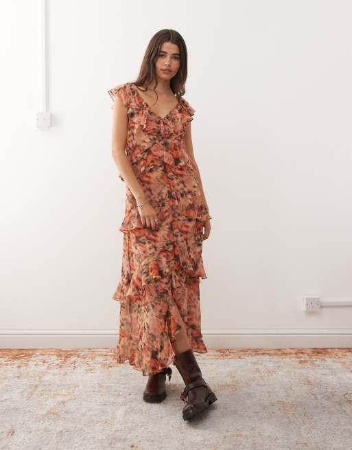 Reclaimed Vintage midi dress with asymmetric hem and ruffles in blurred orange floral print