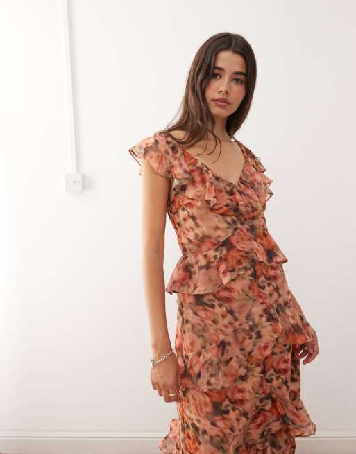 Reclaimed Vintage midi dress with asymmetric hem and ruffles in blurred orange floral print