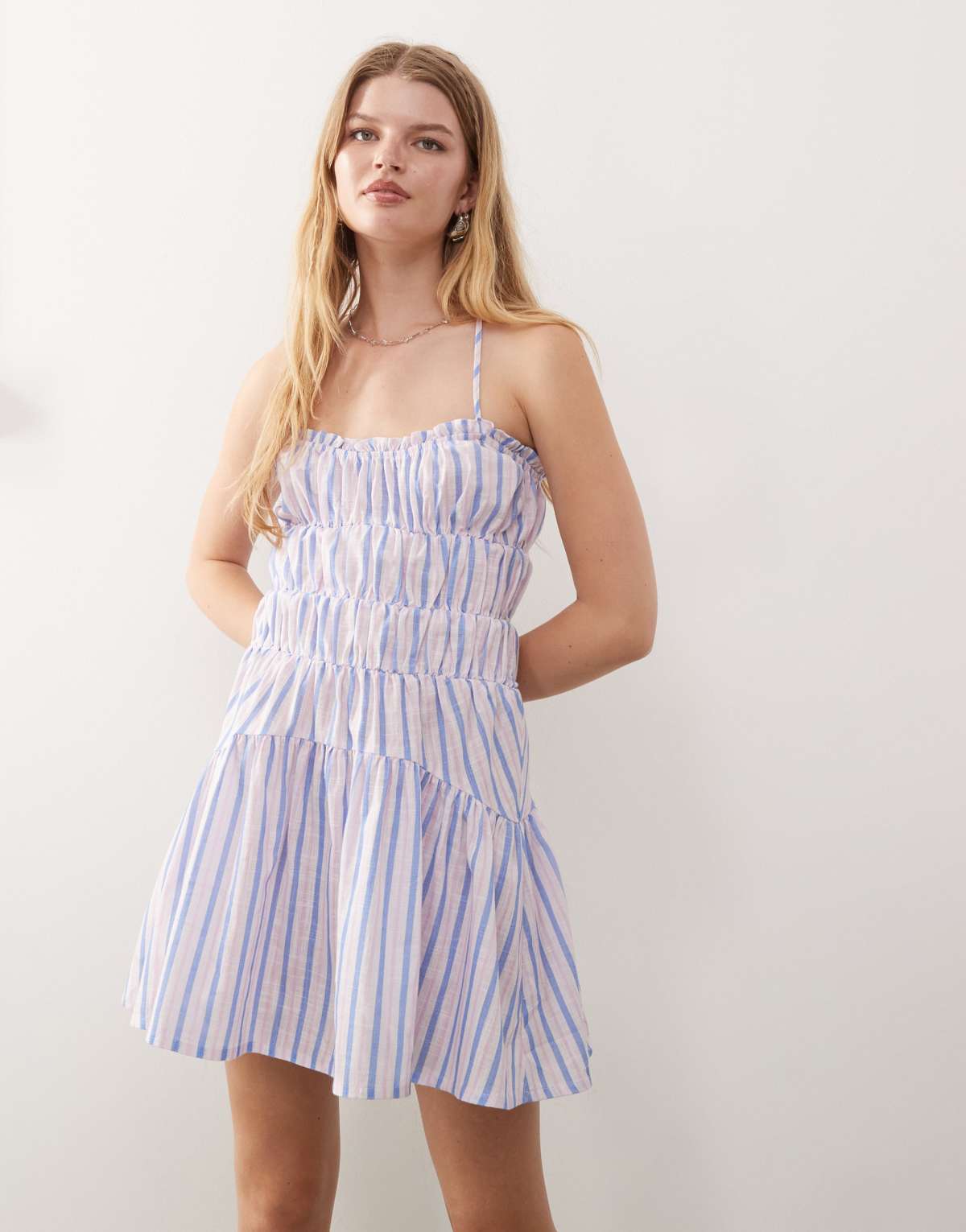Reclaimed Vintage mini sun dress with ruching and cross back detail in purple stripe