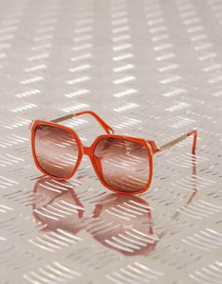 oversized circle sunglasses with red lens in orange