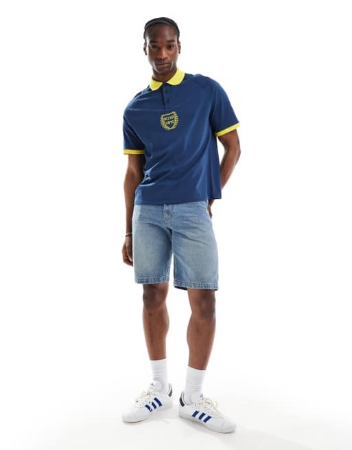 Reclaimed Vintage oversized sports polo top in navy and