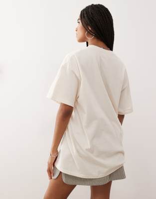 Reclaimed Vintage oversized t-shirt with holiday doodle print in butter yellow
