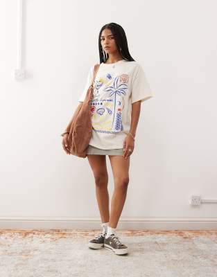 Reclaimed Vintage oversized t-shirt with holiday doodle print in butter yellow