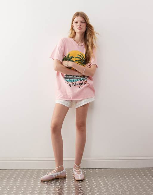 Reclaimed Vintage oversized t-shirt with palm tree holiday print in pink
