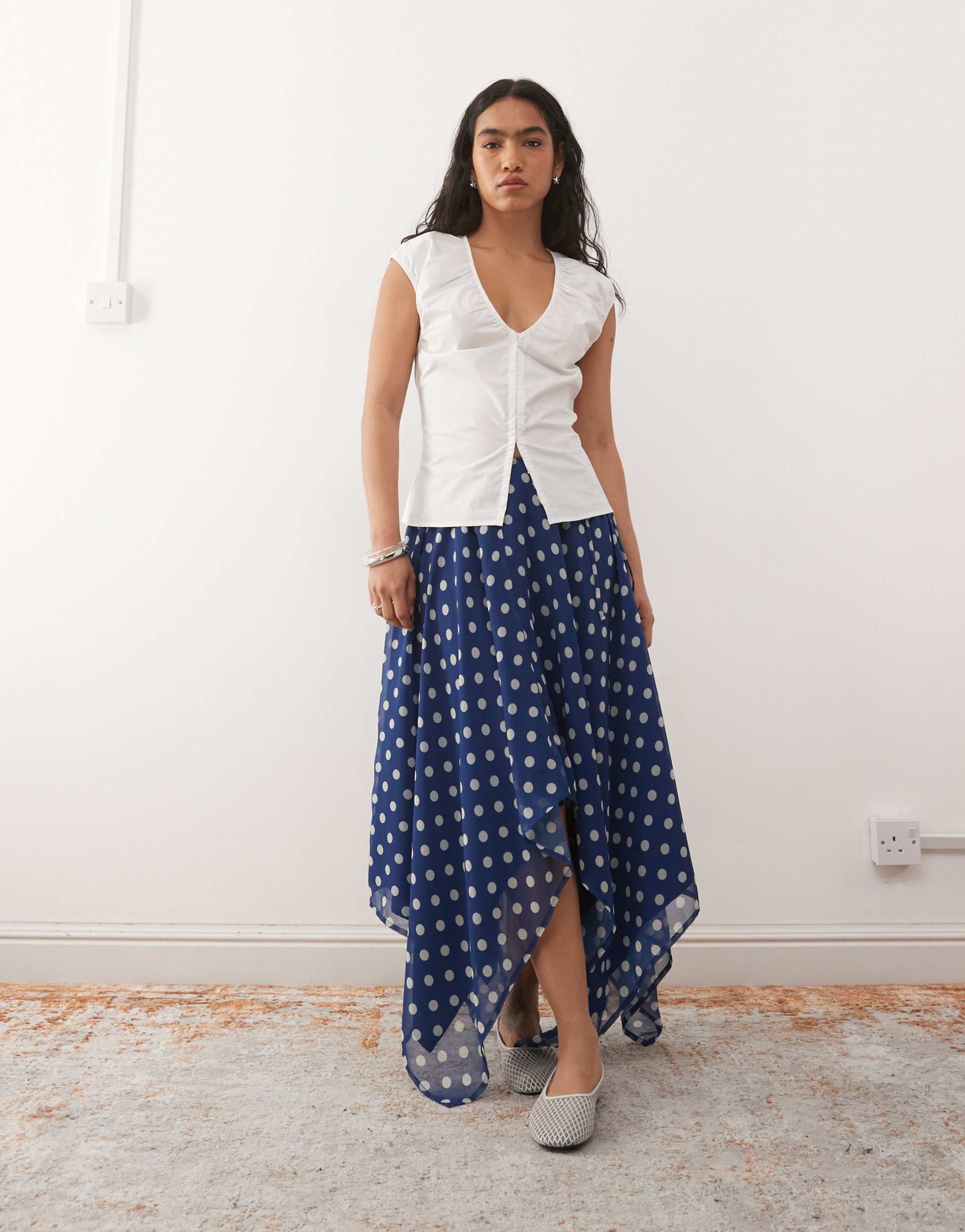 reclaimed vintage ruched midi skirt with asymmetric hem in navy polka dot print