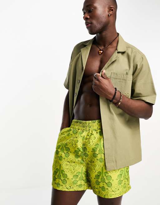 Reclaimed Vintage short length swim shorts in baroque print