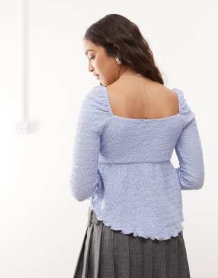 Reclaimed Vintage - Gestructureerde blouse met franjes en strik aan de voorkant in blauw