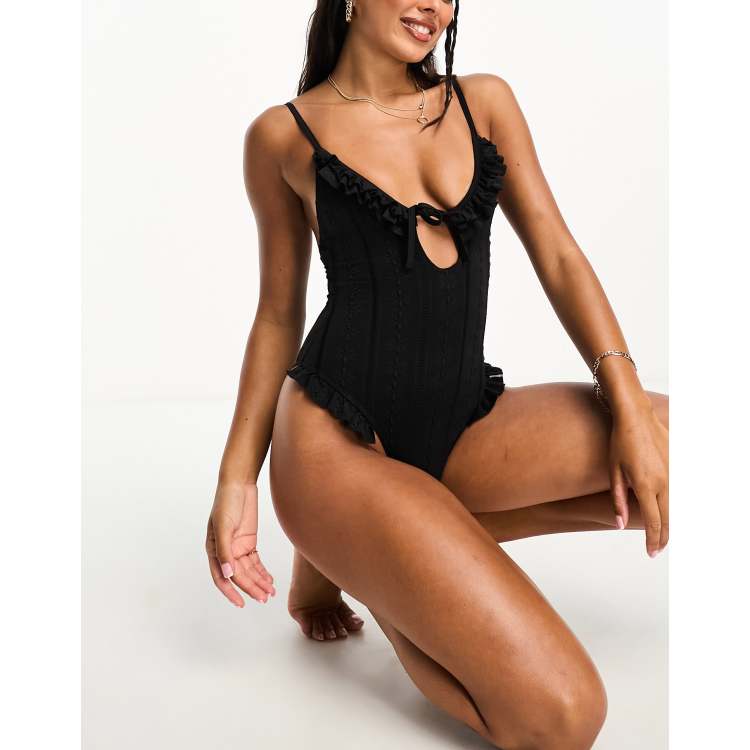 Reclaimed Vintage tie front swimsuit with ruffles in black broderie