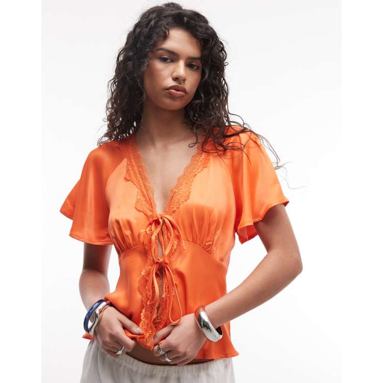 Reclaimed Vintage tie front top with lace trim in orange | ASOS