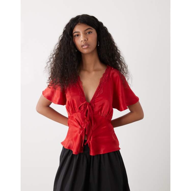 Reclaimed Vintage tie front top with lace trim in red satin | ASOS