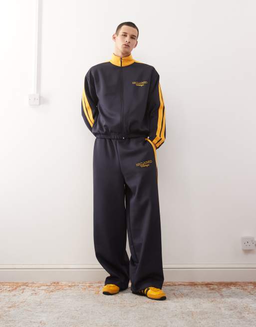 Reclaimed Vintage tracksuit in navy with side stripe