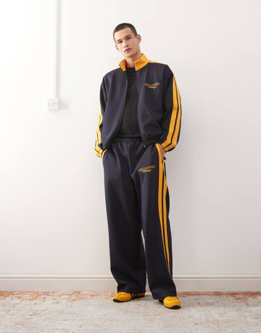 Reclaimed Vintage wide leg sweatpants in navy with side stripes - part of a set