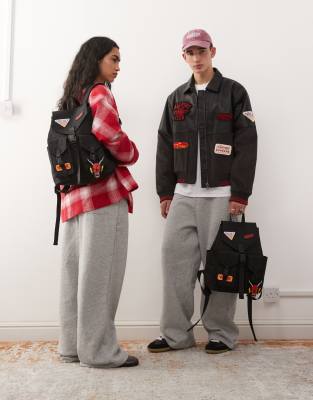 Reclaimed Vintage X Stranger Things Unisex Backpack With Badges In Black