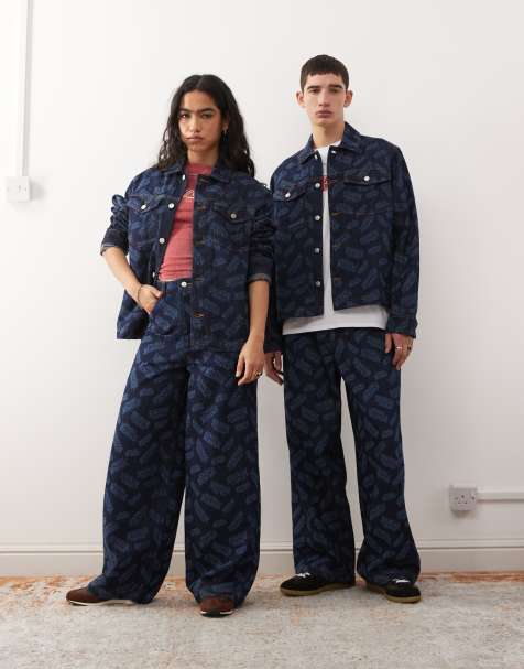 Reclaimed Vintage x Stranger Things unisex baggy jeans with laser print logo in mid blue - view 1