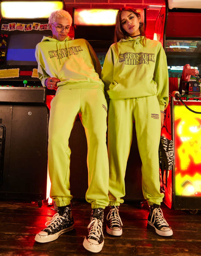 Reclaimed Vintage x Stranger Things unisex sweatpants in washed yellow with logo