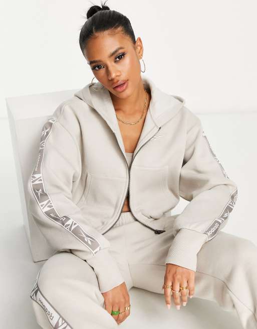 Reebok - Felpa con cappuccio color avena con zip e fettucce