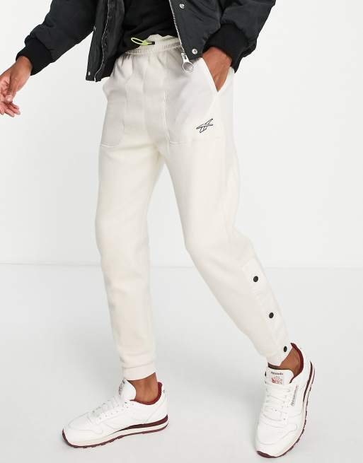 Reebok - MYT - Joggers color crema con fermacorda
