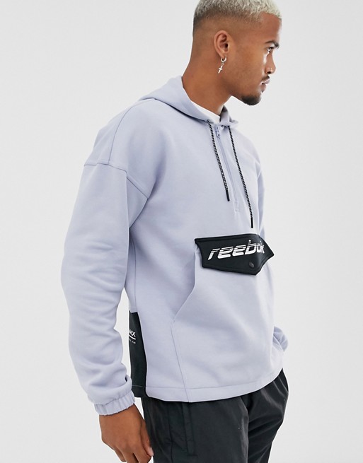 Reebok overhead half zip jacket in blue with logo pocket