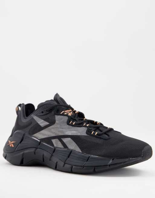 Reebok Running Zig overbranded trainers in black and orange