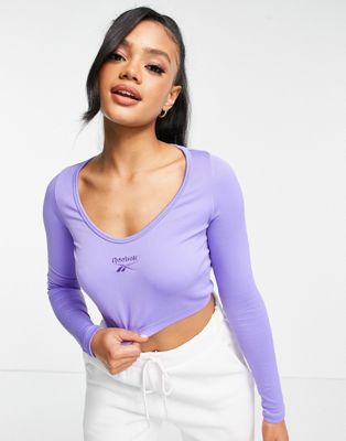 Reebok small central logo cropped long sleeve top in purple