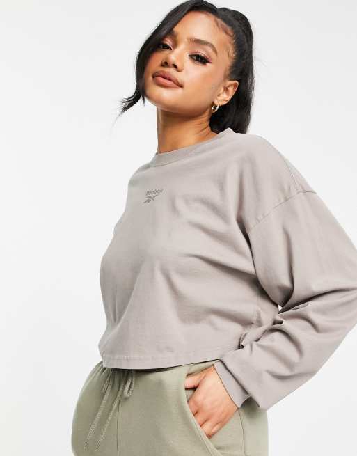 Reebok small central logo long sleeve top in beige