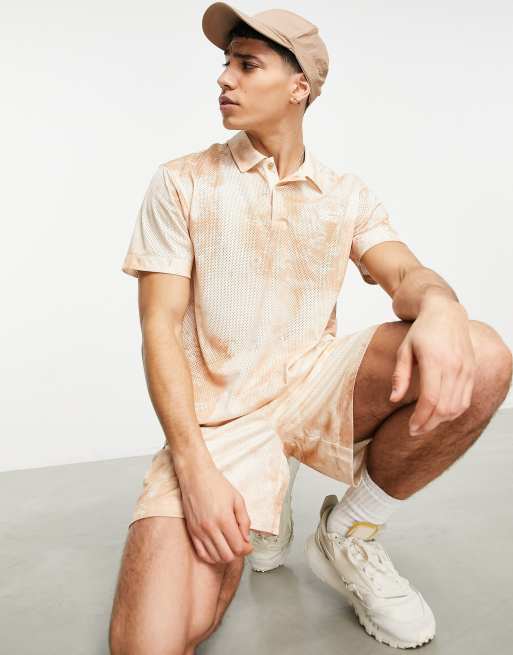 Ungkarl spole bungee jump Reebok - Summer Retreat - Polo en tulle imprimé - Beige | ASOS