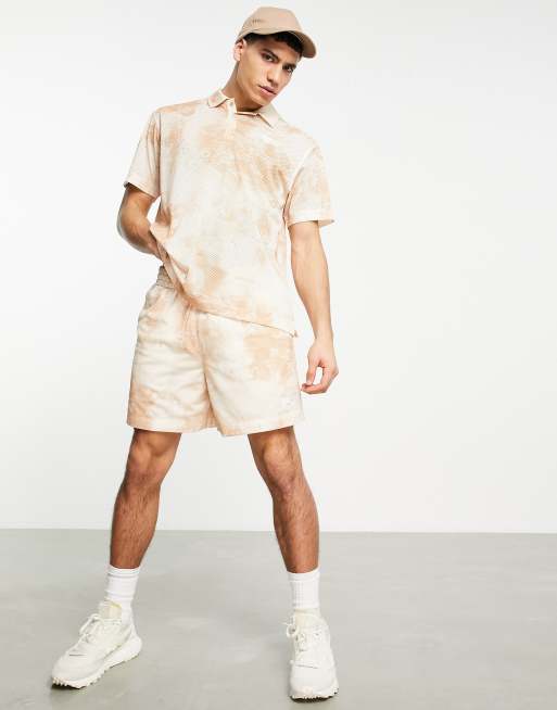 Ungkarl spole bungee jump Reebok - Summer Retreat - Polo en tulle imprimé - Beige | ASOS