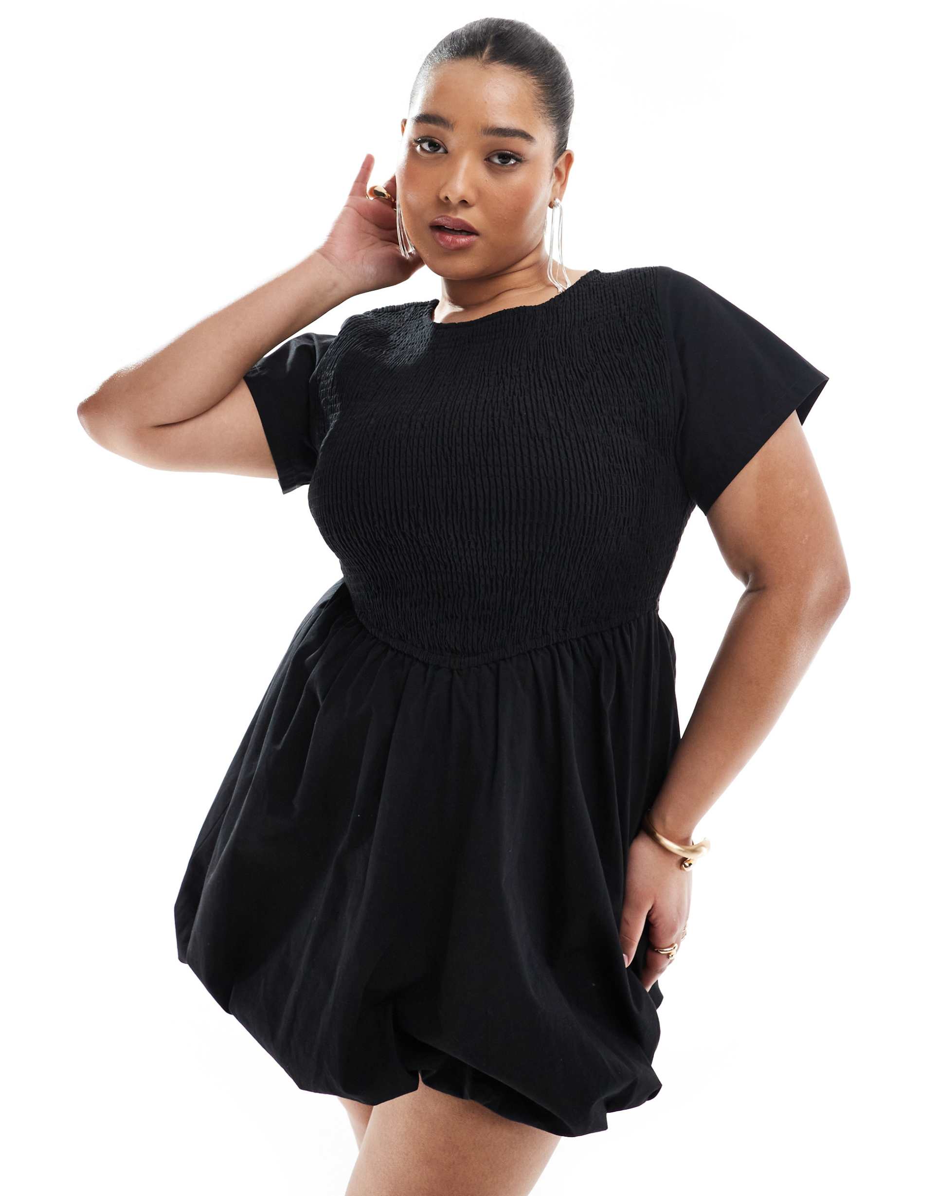 A plus-size, black, bubble mini dress with short sleeves