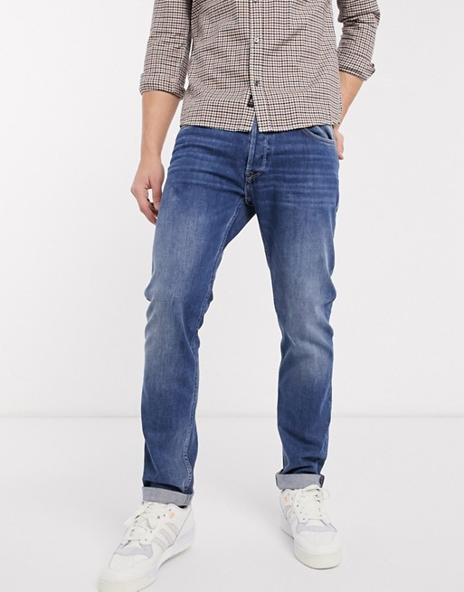 Replay Donny slim tapered fit jeans in mid wash