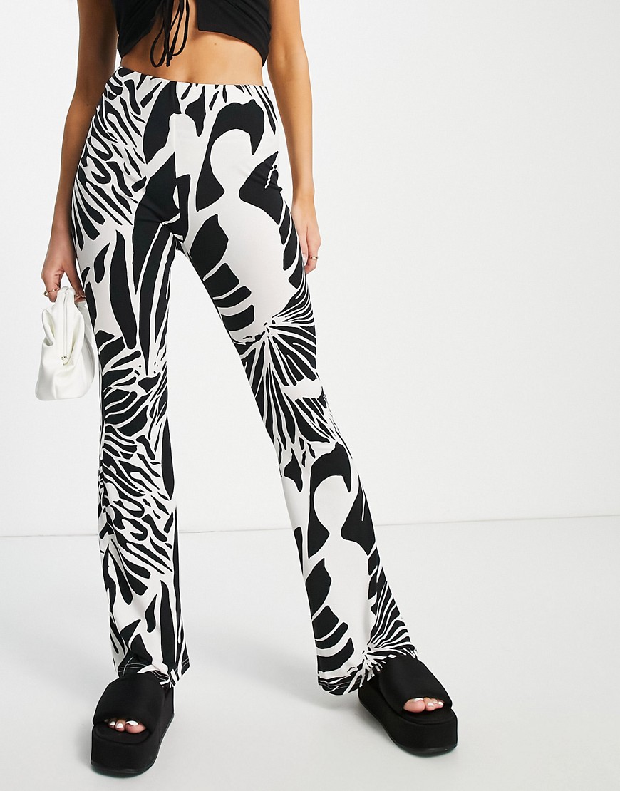 River Island abstract wing print flare pants in cream-White