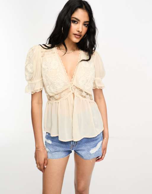 River Island - Blusa peplo in pizzo color crema