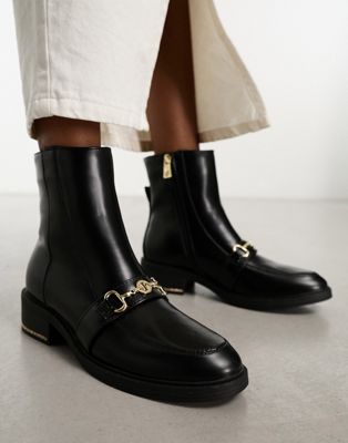boot with gold buckle detail in black