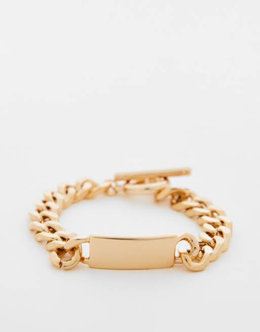 River Island - Bracciale con targhetta e catena barbazzale color oro