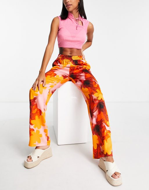 River Island - Broek van satijn met wijde pijpen en bloemenprint in oranje 