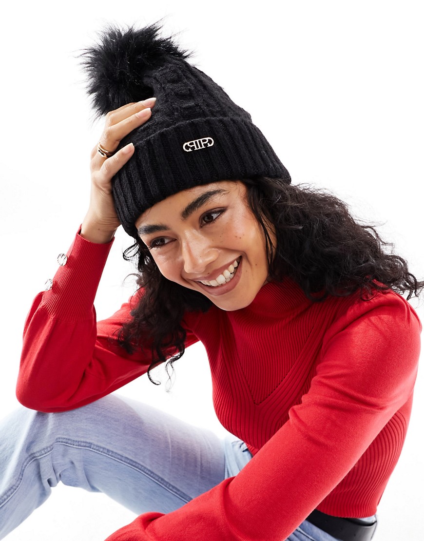 cable knit pom beanie in black-White