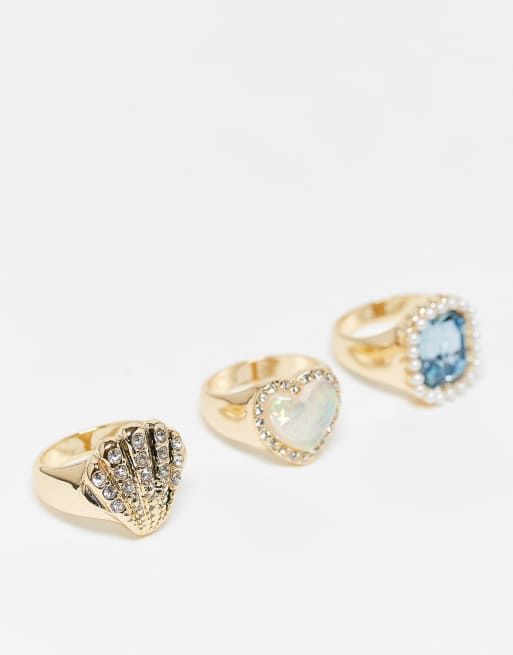 River Island - Confezione da 3 anelli con conchiglia e gemme color oro